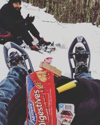 Low section of people standing on snow