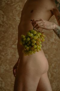 Low section of guy holding grapes