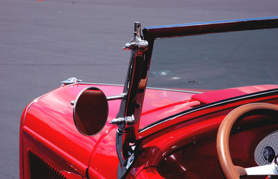 Close-up of red vintage car parked on road