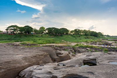 Scenic view of rocks on field against sky