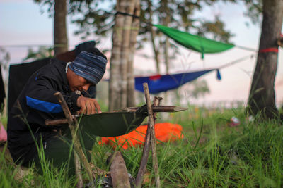 Man holding umbrella on field