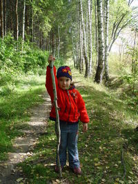Portrait of boy standing in forest
