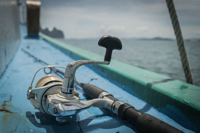 Old fishing rod on the boat under sunlight