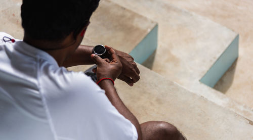 Sport runner black man wear modern time smart watch he sitting resting before training running