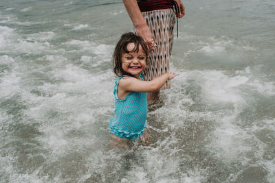Portrait of happy girl playing in water