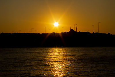 Scenic view of sea against orange sky