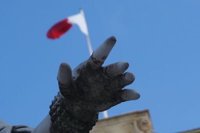 Low angle view of statue against blue sky