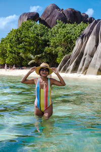 Rear view of woman swimming in lake