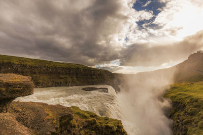 Scenic view of waterfall against sky