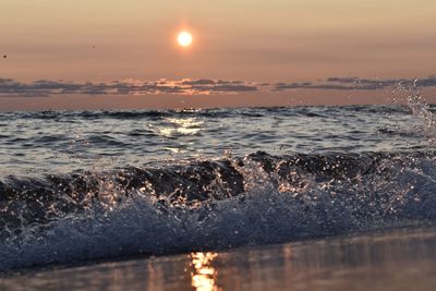 Close-up of sea against sky during sunset