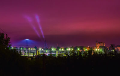 Panoramic view of illuminated city against sky at night