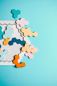 Close-up of jigsaw pieces on blue table