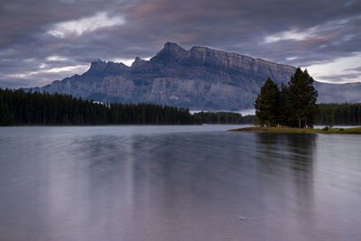 Scenic view of lake by mountains against sky