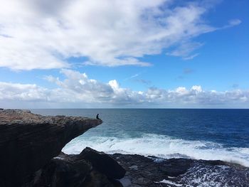 View of calm beach against blue sky