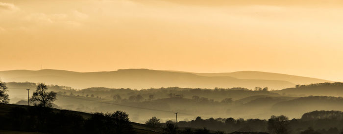 Scenic view of mountains against sky during sunset