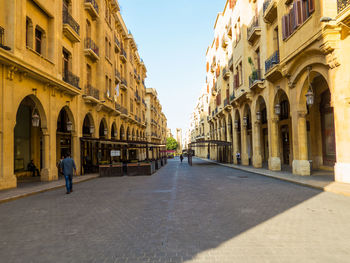 Street amidst buildings in city against sky