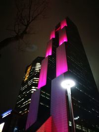 Low angle view of illuminated building against sky at night