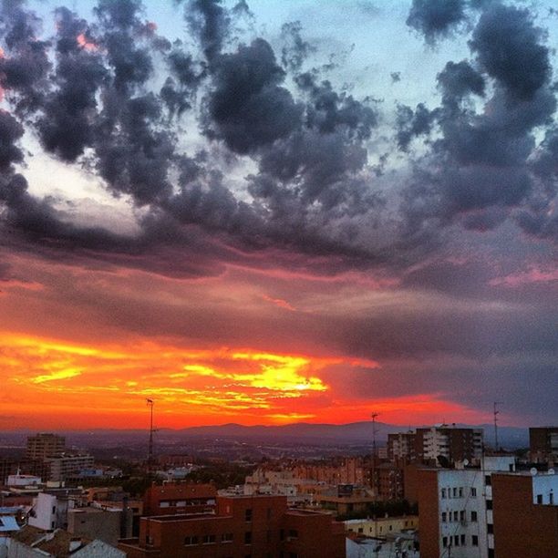 building exterior, architecture, built structure, sunset, cityscape, city, sky, residential district, cloud - sky, crowded, residential building, residential structure, high angle view, orange color, townscape, house, town, cloudy, cloud, community