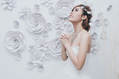 Bride standing against wall