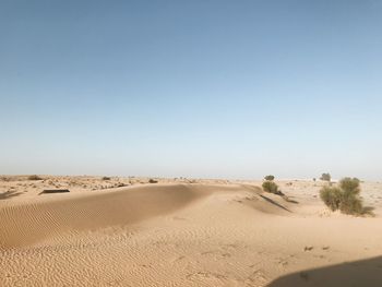 Scenic view of desert against clear blue sky