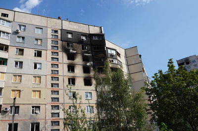 Low angle view of destroyed buildings against sky