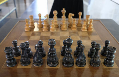 Wooden chessboard with one pawn looking different than the others