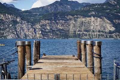 Wooden pier over lake against mountains