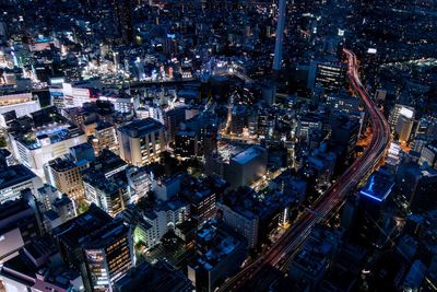 High angle view of illuminated buildings in city at night