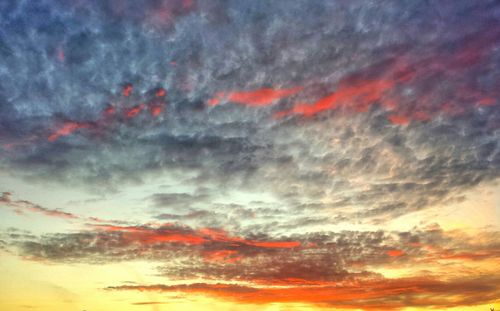 Low angle view of cloudy sky at sunset