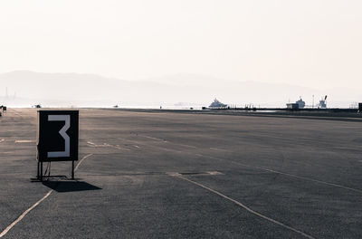 Number at airport runway against clear sky