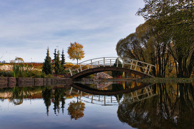 Arch bridge over lake against sky