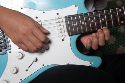 Cropped hands of person playing guitar