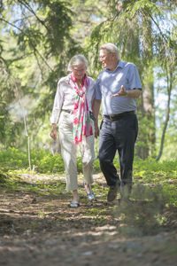 Rear view of people standing in forest