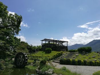 Gazebo on field against sky