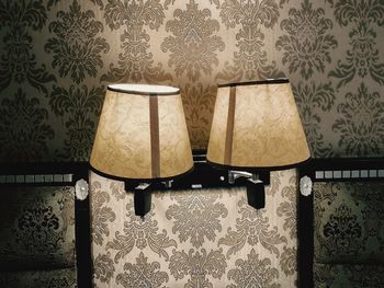 Electric lamp hanging on wall at home