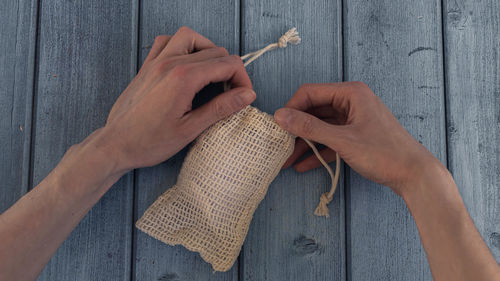 Zero waste. woman hands open eco bag with reusable cotton pad. eco-friendly and sustainable concept.