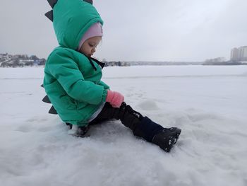 Low section of child skiing on snow