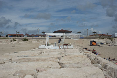 Woman standing by gazebo at beach