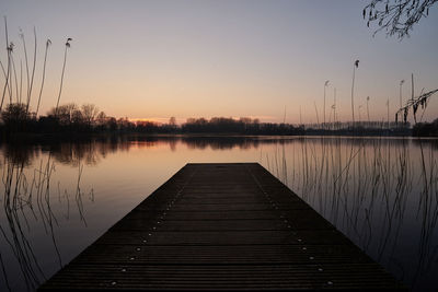 Boardwalk on landscape against blue sky