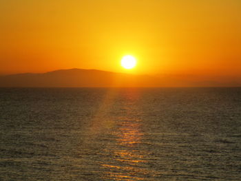 Scenic view of sea against orange sky during sunset