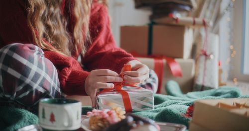 Midsection of woman having food at home