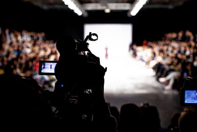 People photographing at music concert