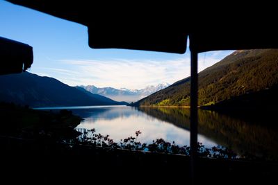 Scenic view of lake and mountains seen from balcony