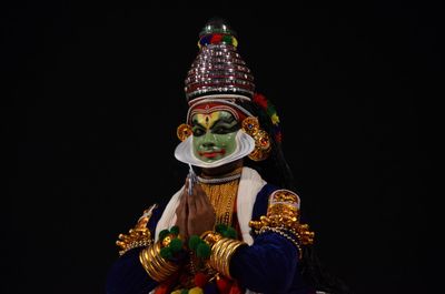 Low angle view of statue against black background