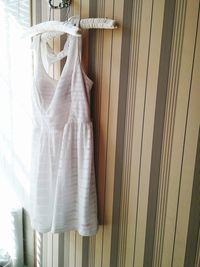 Close-up of dress hanging against wall at home