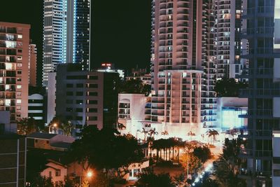 View of skyscrapers lit up at night