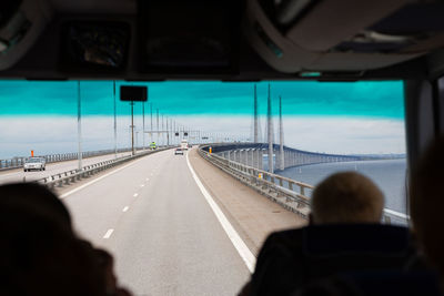 View of oresund bridge from tourist bus. copenhagen bus tour. tourists in bus enter oresund bridge. 