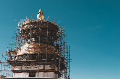 Low angle view of temple tower against clear sky