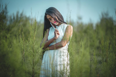 Young woman standing on field