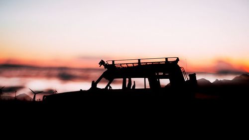 Silhouette built structure against clear sky at sunset